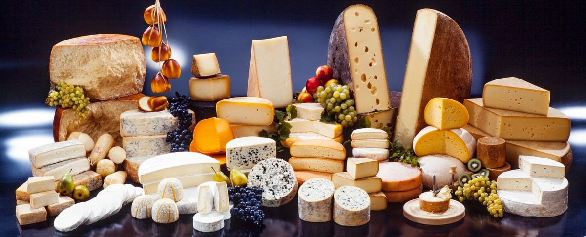 Assorted cheese varieties including Brie, Cheddar, and Parmesan, showcasing rich flavors and nutritional benefits, ideal for a balanced diet in Kuwait. - dairy products list